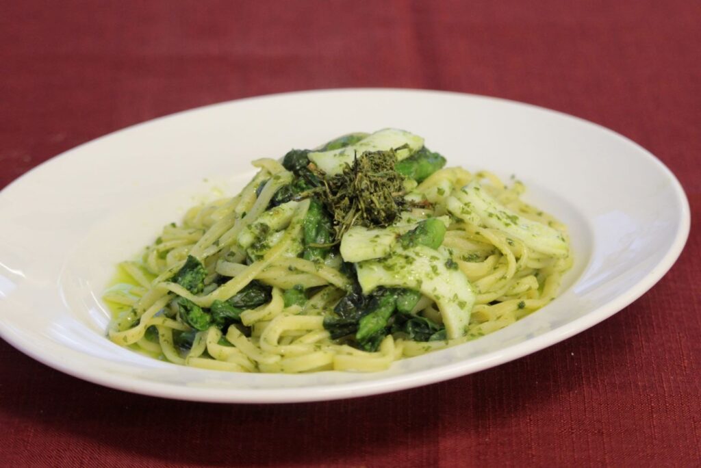 A plate of pasta topped with green tea leaves at d:matcha Kyoto Cafe and Kitchen